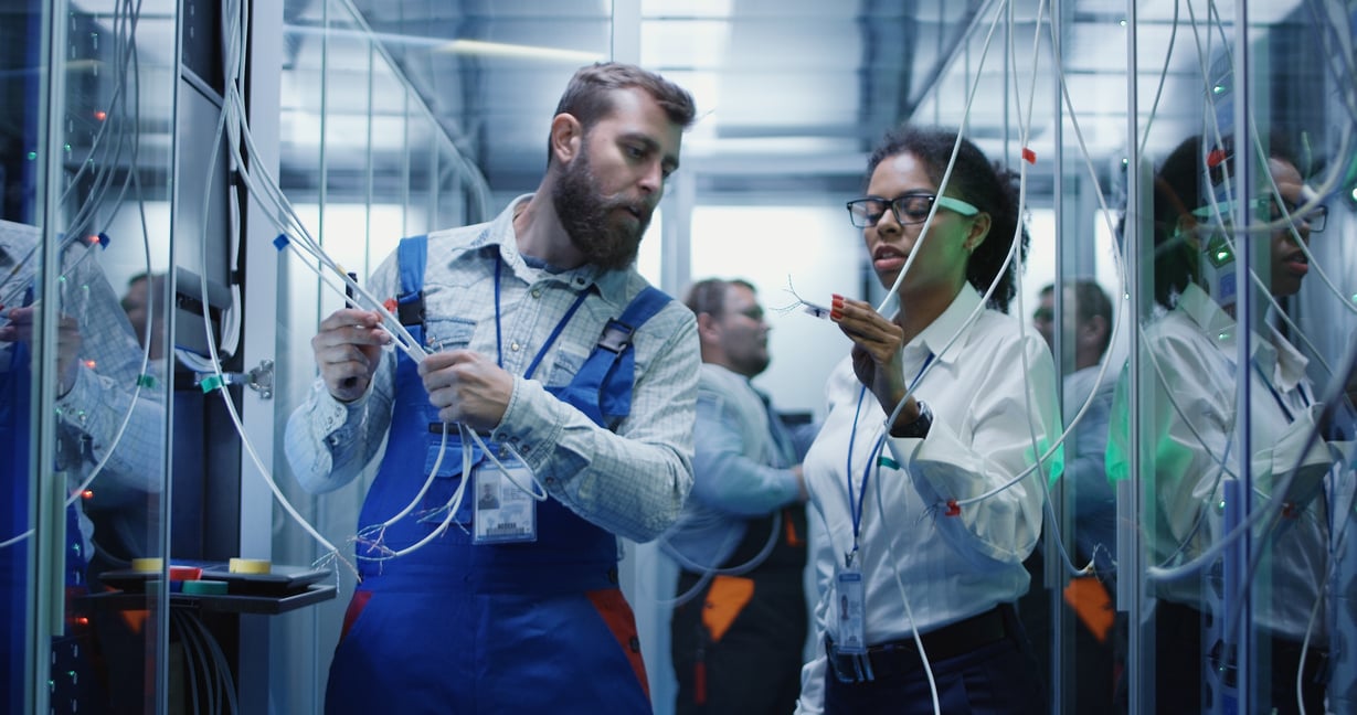 Three people working in a data center